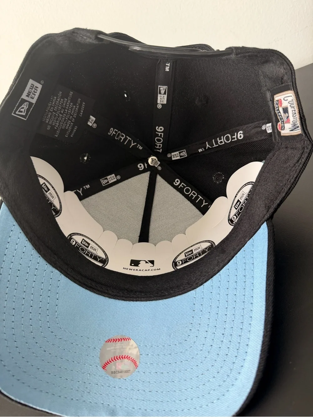 New Era Black Cap with White 'A' and Blue Cloud Embroidery